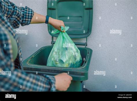 European 30s Woman Throwing Garbage Into The Recycling Bin In The