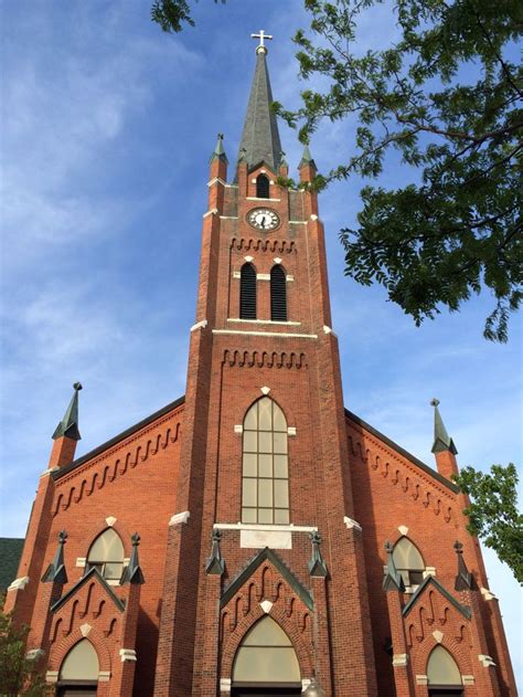 An Old Brick Church With A Clock Tower