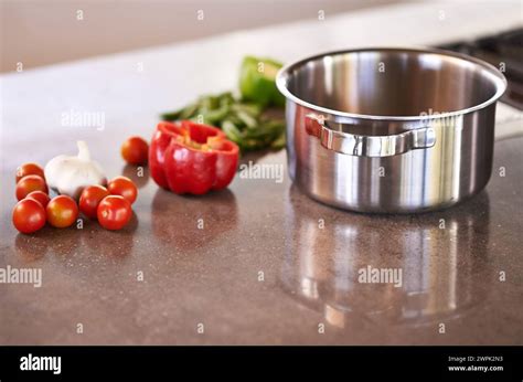 Kitchen Counter Pot And Vegetable Ingredients To Cook For Healthy Meal And Supper For