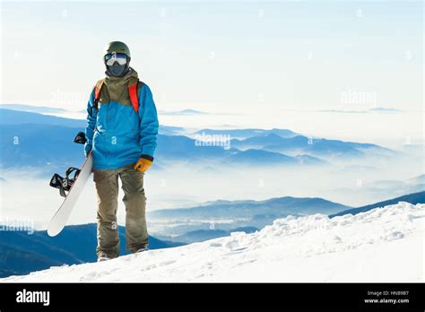 Close Up Shot Of A Snowboarder In Helmet Standing At The Top Of A