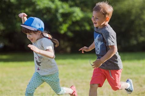 Premium Photo | Happy little kids playing catch-up