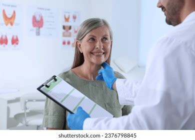 Endocrinologist Examining Thyroid Gland Patient Hospital Stock Photo