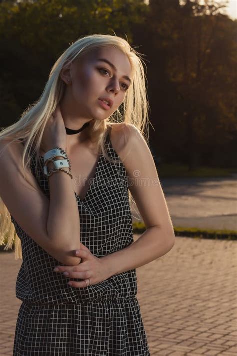 Glamorous Blonde Model In Black Romper Posing In The City In Sun Stock