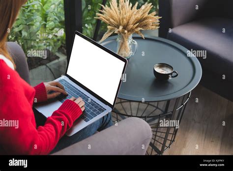 Young Woman Wearing Red Sweater Typing On Computer At Home Female