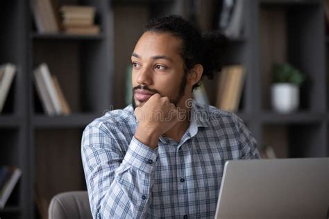 Thoughtful Pensive Black Freelance Employee Guy Working At Laptop Stock