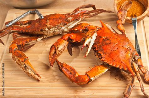 Pile Of Steamed And Seasoned Chesapeake Bay Blue Claw Crabs On A Wood Cutting Board With A