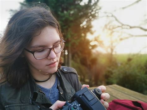 Premium Photo Close Up Of Woman Holding Camera Outdoors