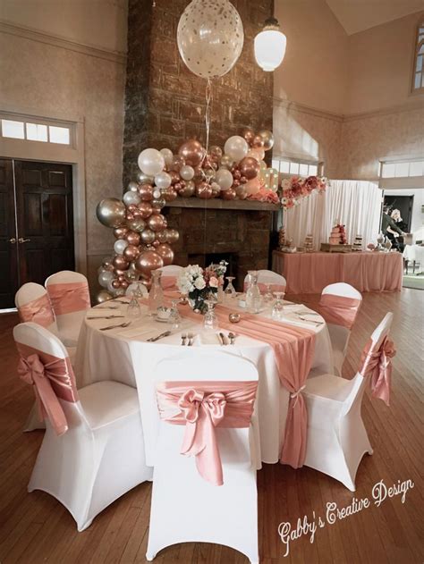 A Room Filled With Tables Covered In White And Pink Table Cloths Next