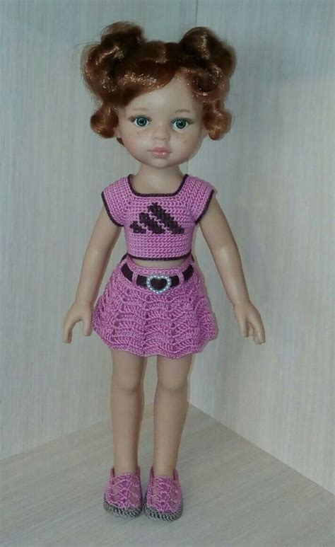 The Doll Is Wearing A Purple Dress And Pink Shoes With Her Hair In Pigtails