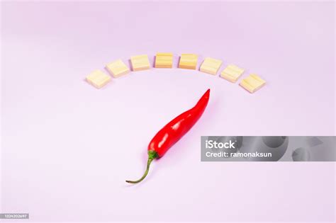Hot Chilli Indicates Hotness Scale On Pink Background Stock Photo