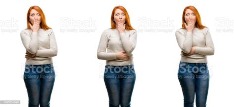 Young Beautiful Redhead Woman Covers Mouth In Shock Looks Shy Expressing Silence And Mistake