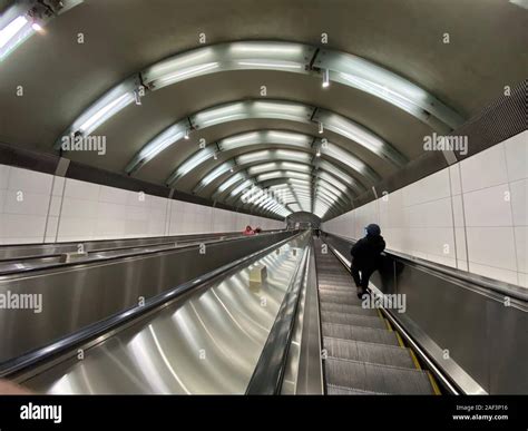 Commuter On Long Escalator Down Into New York Subway Station Stock