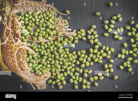 Mung Beans Vigna Radiata Spilling From Burlap Bag On Black Wooden