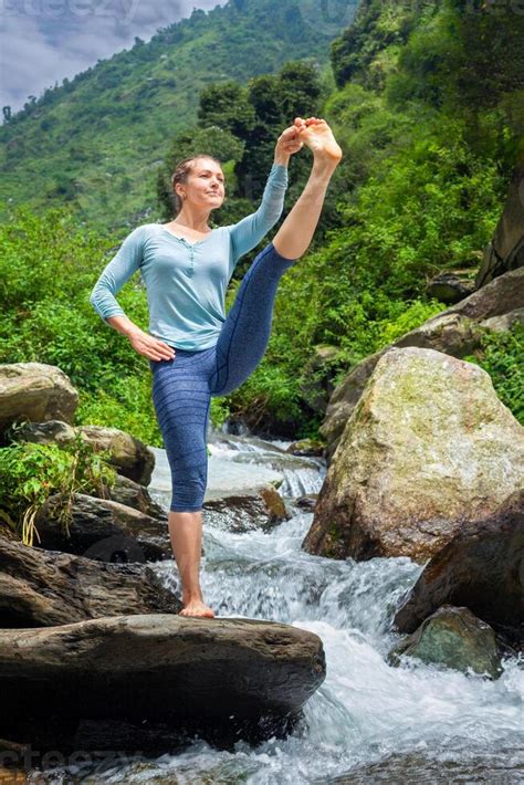 Woman Doing Ashtanga Vinyasa Yoga Asana Outdoors At Waterfall 40942918