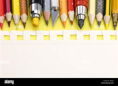 Yellow Writing Desk Background With Paper And Colorful Pencils Macro