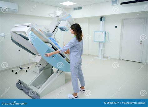 Radiologic Technologist Preparing Adult Patient For Radiology