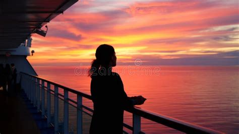 Woman Silhouette on Deck of a Cruise Ship, Looking Out at the Sunset ...