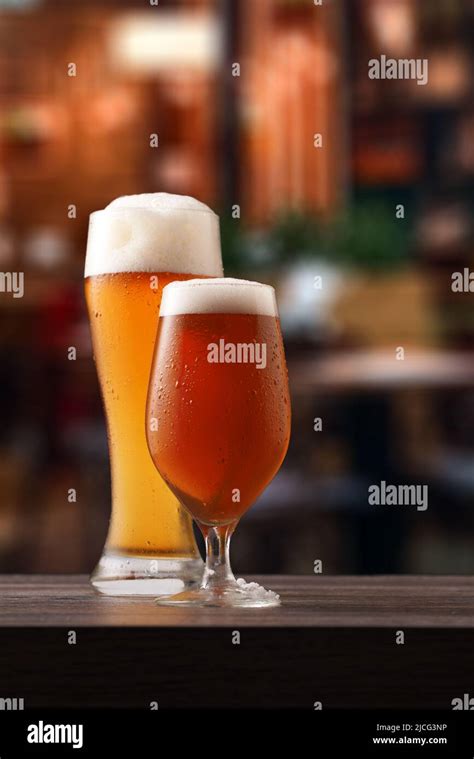 Two Glasses Of Beer On Counter In Pub Alcoholic Beverage Over Pub