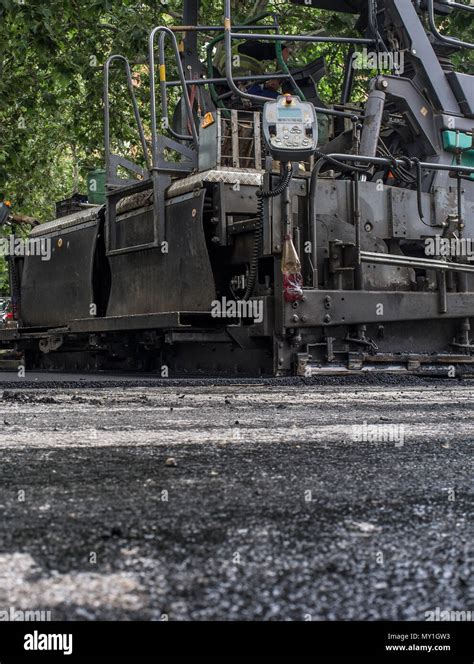 Work On The Laying Of Asphalt In The City Paving Applicator Machine Or