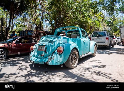 Man driving retro vintage classic style car on road amidst traffic ...