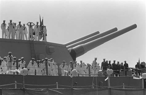 Crew Members Man The Rails And Stand A Top A Inch Gun Turret As The