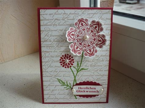 A Close Up Of A Card On A Table Near A Window With A Flower In It