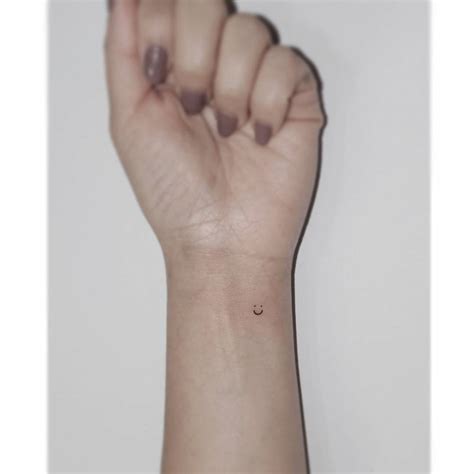 Tiny Smiley Face Tattooed On The Wrist Minimalistic