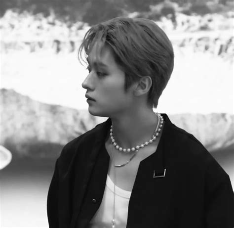 An Image Of A Woman That Is Standing In Front Of The Ocean With Pearls