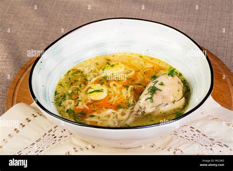 Chicken soup with leg and noodle Stock Photo - Alamy