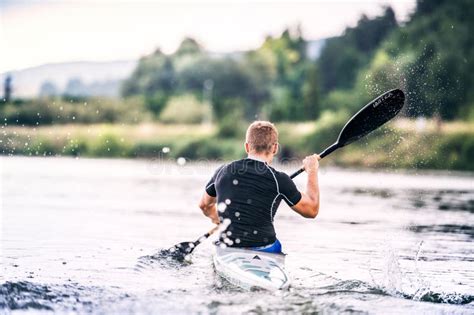 Canoeist Man Sitting In Canoe Paddling In Water Concept Of Canoeing