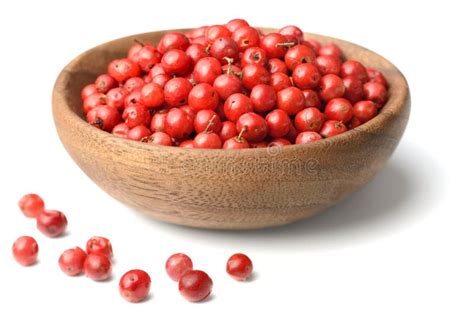 Dried Pink Peppercorns In The Wooden Plate Isolated On White Stock