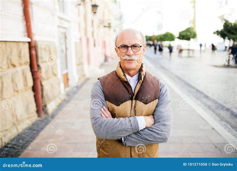 Portrait Of Caucasian Mature Man Smiling At Camera With Crossed Hands Stock Photo Image Of