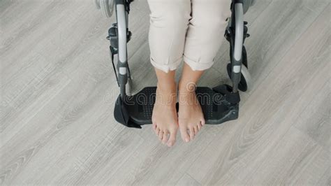 Close Up High Angle View Of Naked Female Feet In Modern Wheelchair