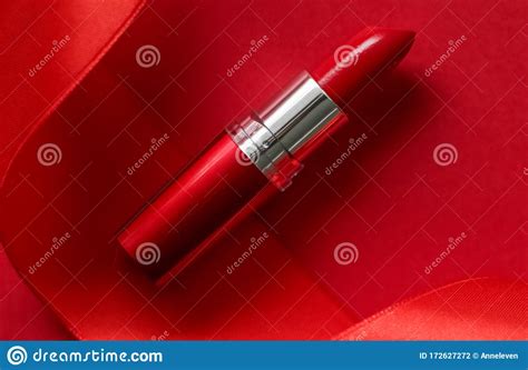 Luxury Lipstick And Silk Ribbon On Red Holiday Background Make Up And