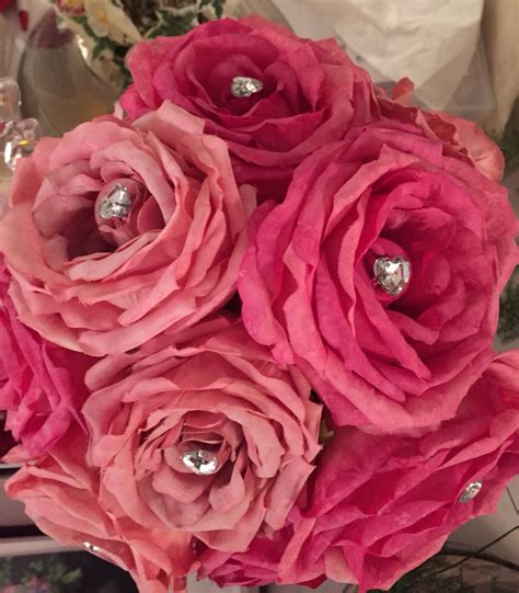 A Bouquet Of Pink Flowers Sitting On Top Of A Table