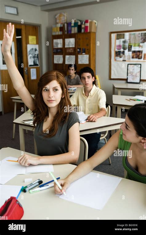 High School Student Raising Hand In Class Stock Photo Alamy