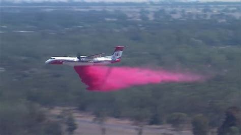 Crews battle out-of-control bushfires from the air in southern ...