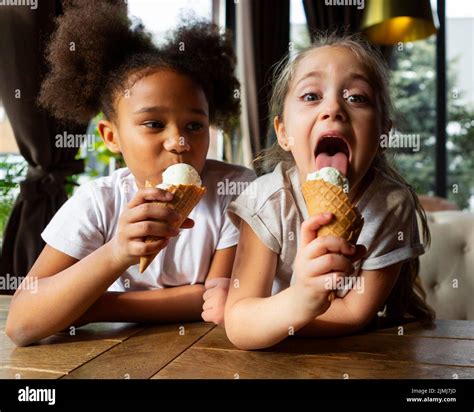 Medium Shot Girls Eating Ice Cream Stock Photo Alamy