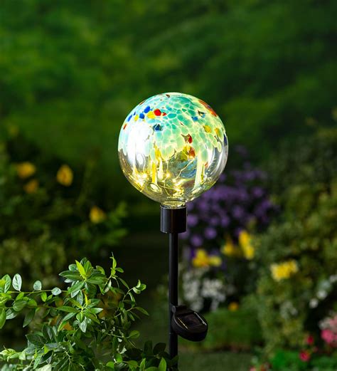 Light Blue Glowing Glass Solar Lighted Orb On Metal Stake Wind And Weather