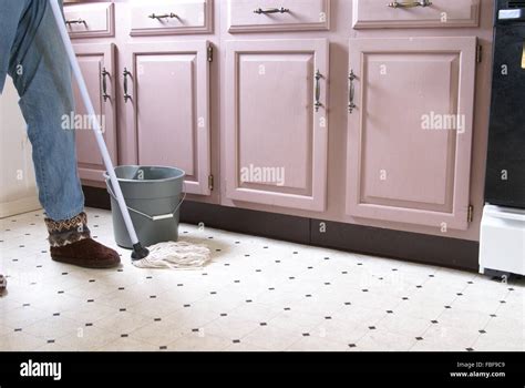 Mopping the kitchen floor Stock Photo - Alamy