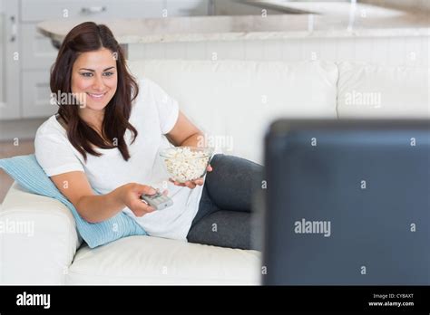 Brunette Changing Channel On Tv Stock Photo Alamy