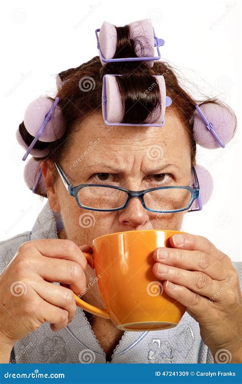 Grumpy Woman In Curlers Drinking Coffee In The Morning Stock Image