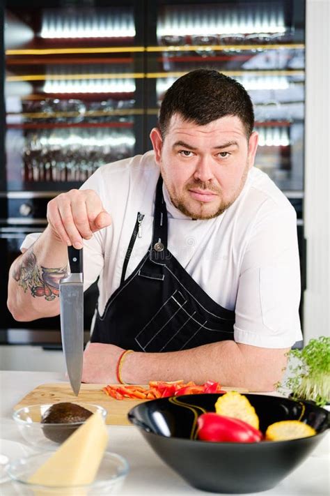 40 Years Man Chef Cooker in a White Uniform and a Black Apron in the ...