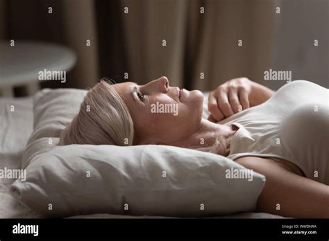 Sleepless Mature Woman Lying In Bed Suffering From Insomnia Stock Photo Alamy