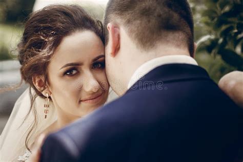 Sensual Groom Kissing Beautiful Bride On The Forehead Newlywed Couple