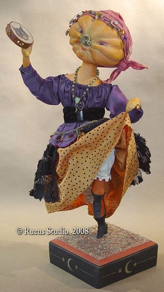 A Figurine Of A Woman Holding A Glass