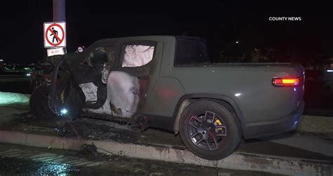 Rivian R1t Crashes Into Pole Fire Ensues But Driver Escapes Unharmed