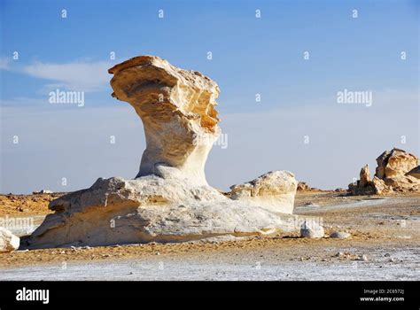 The Unusual Wind Erosion Limestone Formation In White Desert At Sunset