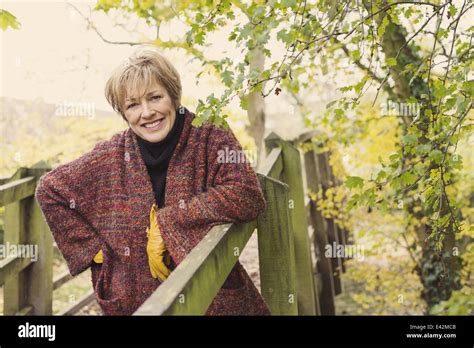 Mature Woman Leaning On Wooden Fence Hi Res Stock Photography And