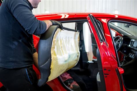 Car Service Worker Disassemble The Interior Of The Car Stock Photo